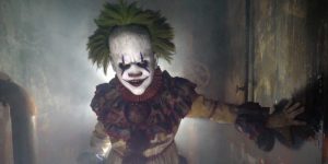 A Scary Clown Peering From A Dark Background.