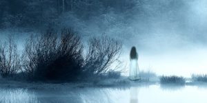 Scary woman's ghost standing in a old creepiest lake.